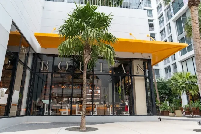 Boûlan Wynwood bakery exterior with a yellow canopy and glass storefront