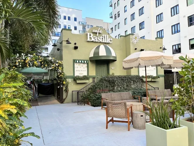 Café Bastille exterior in Fort Lauderdale with an outdoor terrace and palms