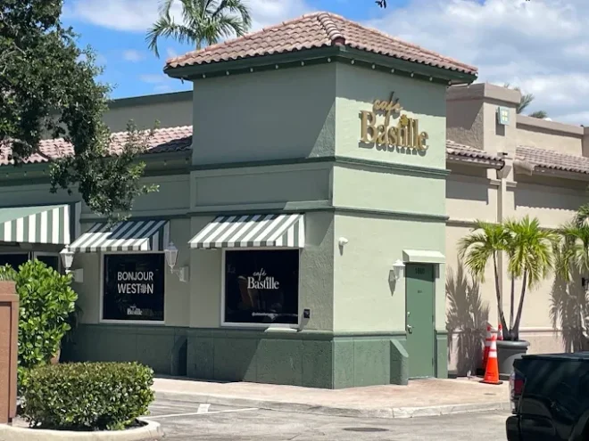 Café Bastille Weston storefront with a pale green facade and clay tile roof