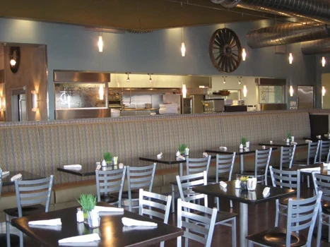 Café tables and chairs in front of an open service counter