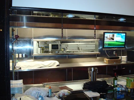 Commercial kitchen service opening and stainless-steel exhaust hood