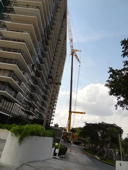 Crane positioned beside a multi-story building