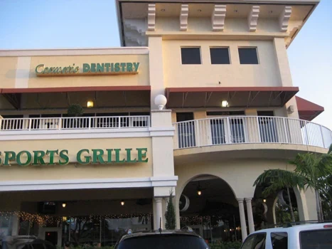 Dental office signage on the upper level of a two-story commercial building