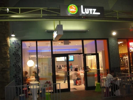Frozen yogurt shop entrance opening onto a food-service seating area