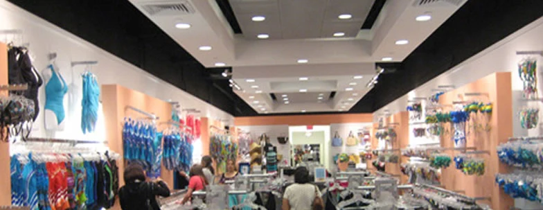 A retail shop interior with merchandise displays and overhead lighting