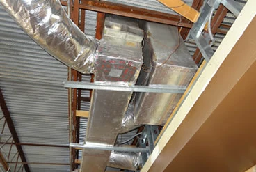 Insulated metal air ducts suspended below exposed roof framing