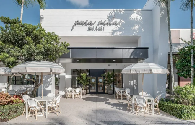 Pura Vida Miami café frontage with outdoor tables and umbrellas