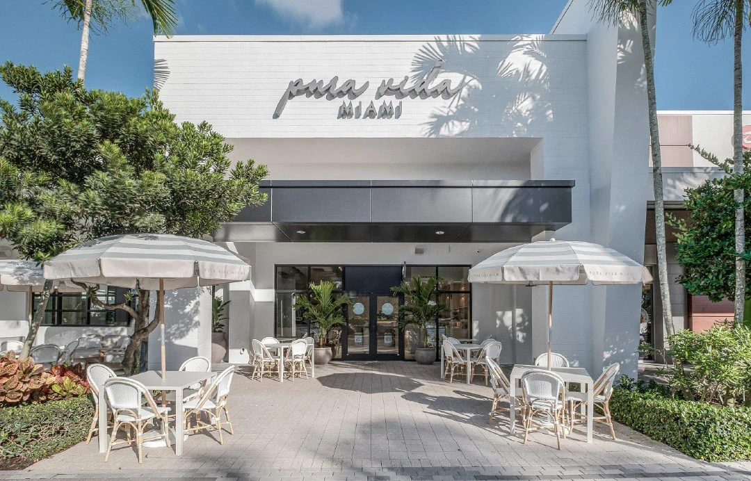 Pura Vida Miami café frontage with outdoor tables and umbrellas